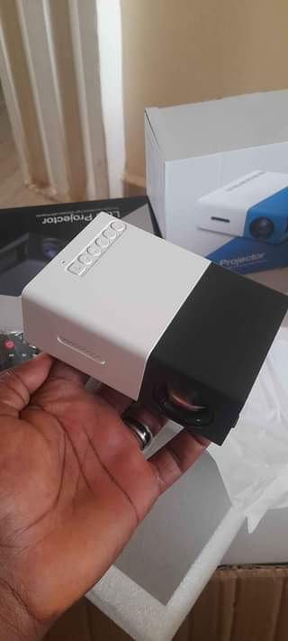 A picture of Promo Mini projector with FREE tripod stand for perfect balance