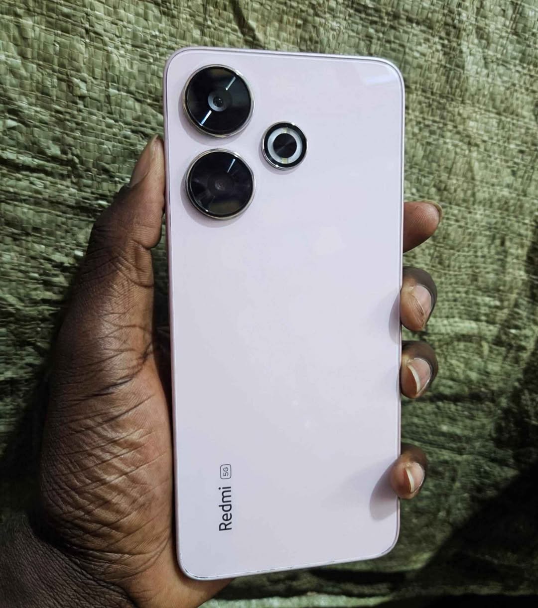 A picture of REDMI 13 5G 128GB MILK CONDITION 300000UGX ONLY TSAP