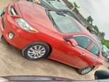 A picture of Red Toyota Corolla for sale tokunbo standard