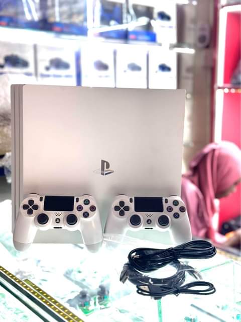 A picture of PS4PRO with 2 controllers and 8games installed