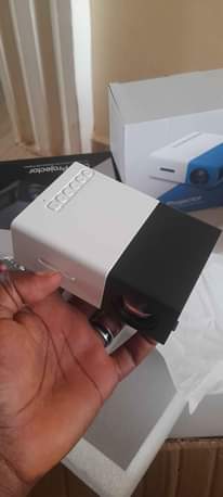 A picture of Promo Mini projector with FREE tripod stand for perfect balance