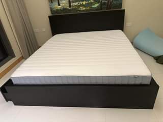 A picture of IKEA Bedframe black brown Vestmarka sprung mattress