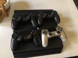A picture of USED PS4 PRO 1TB WITH 4 PADS AT A GIVEAWAY