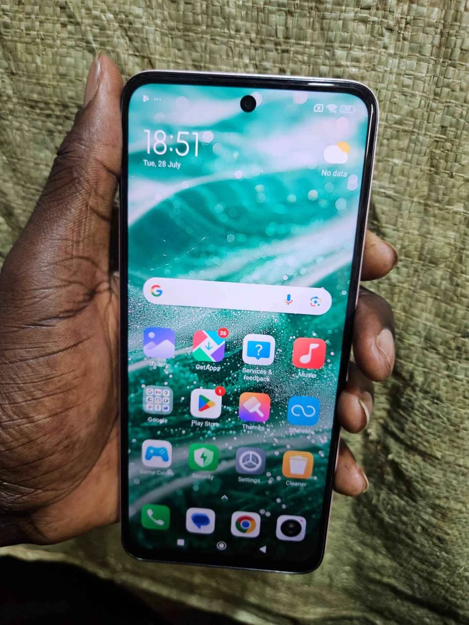 A picture of REDMI 13 5G 128GB MILK CONDITION 300000UGX ONLY TSAP