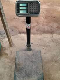A picture of 50 60Kg Gas Cylinder with Scale and Gas pumping machine