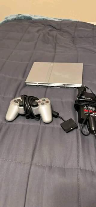 A picture of PS2 for sale at 250k with 10 games and pads