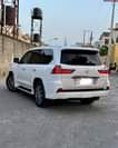 A picture of 2016 Lexus LX570 in pearl white on red interior