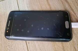 A picture of SAMSUNG GALAXY S6 edge with some cracks but works well