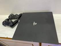 A picture of Sony PlayStation 4 pro with fifa 2022 and 2game controllers