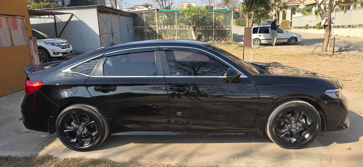 A picture of HONDa Civic Oriel 2025 Black with burgundy