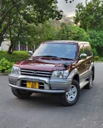 A picture of TOYOTA PRADO Year. 2000 Colour Maroon Engine 1Kz Gear. Automatic
