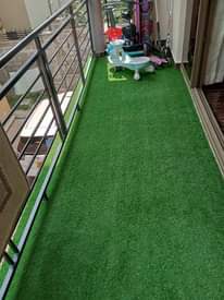 A picture of Artficial turf grass and wall wall woolen carpets