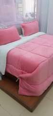 A picture of 3pc woolen blankets 2 pillow cases 1 blanket Sizes 4