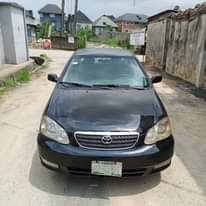 A picture of Must Go Today Sharp Black 2004 Toyota Corolla first body