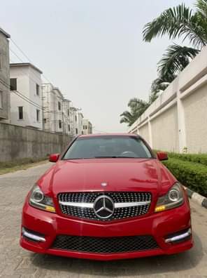 A picture of 2013 Mercedes Benz C250 Foreign Used Red on cream interior