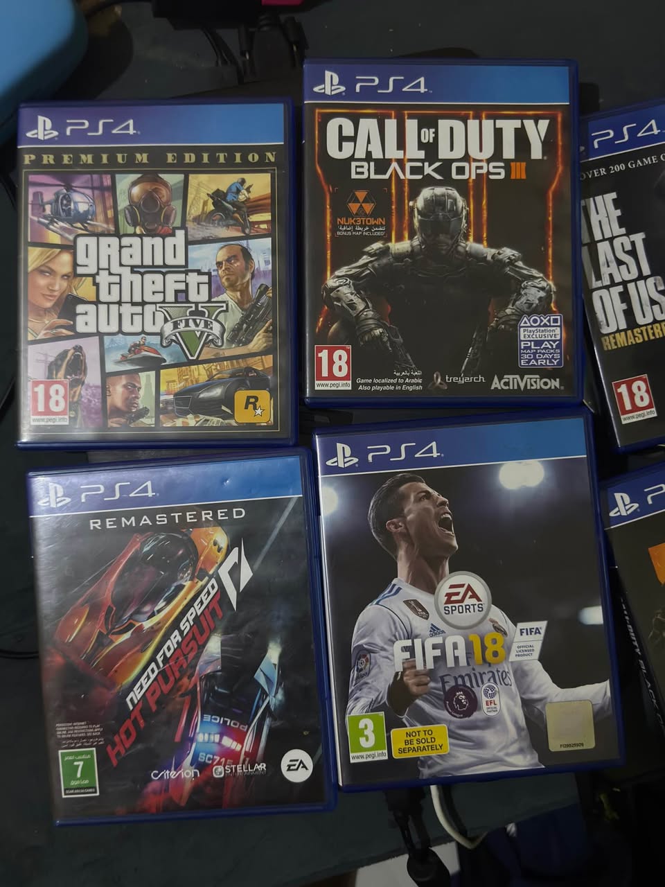 A picture of PS4 slim with 5 CD games and 10 games downloaded