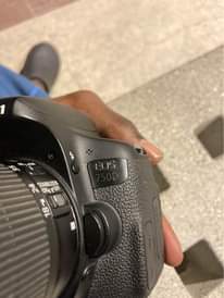 A picture of Canon 750D with two batteries and to charge