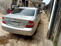 A picture of NIGERIA USED TOYOTA CAMRY 2004 model smoking engine and good