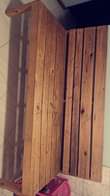 A picture of wooden couch in good condition wide and fits 4 people