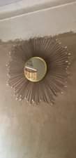 A picture of wall mirror decor lampshades and bottles