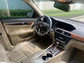 A picture of 2013 Mercedes Benz C250 Foreign Used Red on cream interior