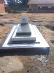 A picture of Grave finishing head stones plaques with writings and photoes