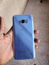 A picture of Samsung s8 plus comes with free screen guard and pouch