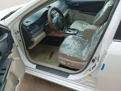 A picture of Distress foreign used 2013 Camry in pristine condition Going for