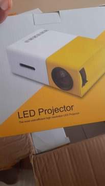 A picture of Mini projector with FREE tripod stand and anti light screen