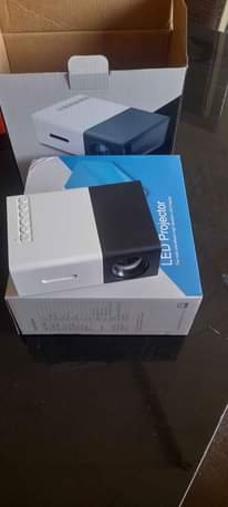 A picture of Promo Mini projector with FREE tripod stand for perfect balance