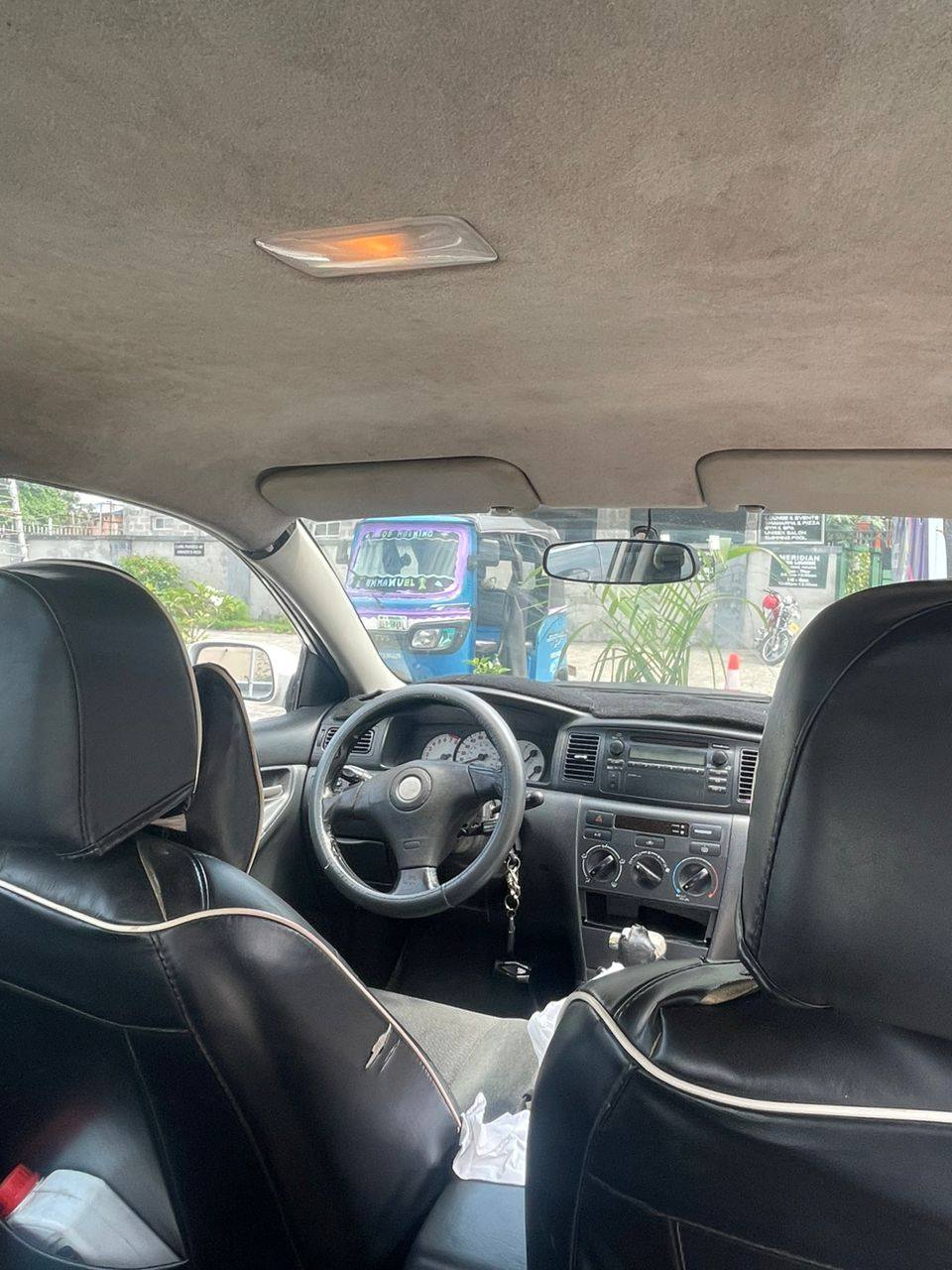 A picture of Sharp 04 Toyota Corolla with untouched engine gear and AC