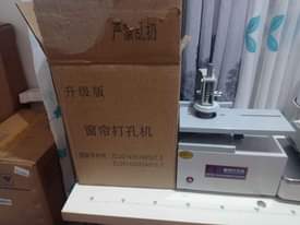A picture of curtains punch machine eyelet curtains machine grommet machine