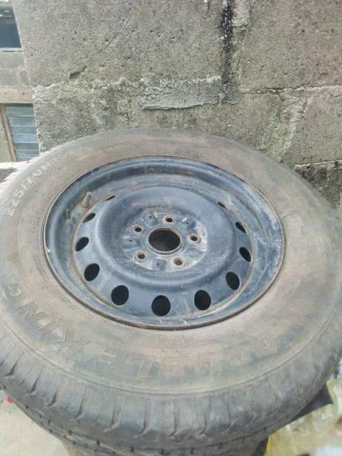 A picture of 5 tyres with rim