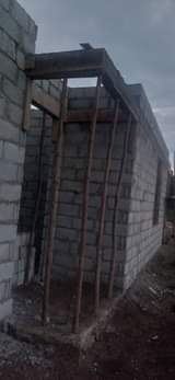 A picture of land and house for sale