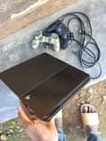 A picture of PLAYSTATION 4 WITH TWO PADS AND 4GAMES CLEAN AS NEW