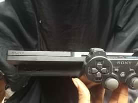 A picture of Ps3 with two follow come pad