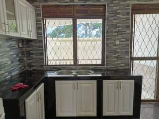 A picture of Classic white house up 4 sale Mukono_KIROWOOZA behind Uganda Christian