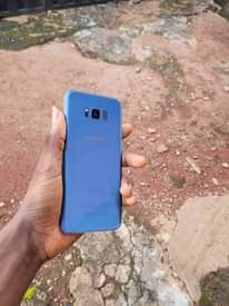 A picture of Samsung s8 plus comes with free screen guard and pouch