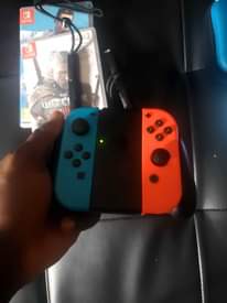 A picture of Nintendo Switch with all original accessories plus games