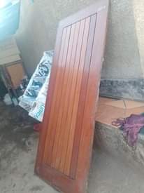 A picture of 6 mahogany and one aluminium door