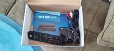 A picture of DSTV Decoder with complete accessories
