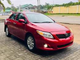 A picture of Pepper red 2010 Corolla Le available Abuja used owner 7m