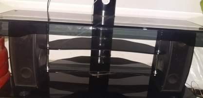 A picture of Tv glass table with hoofer