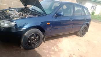 A picture of Mazda 323f Manual drive New baked on first body Tokunbo