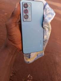 A picture of A very clean phone with the original accessories and also
