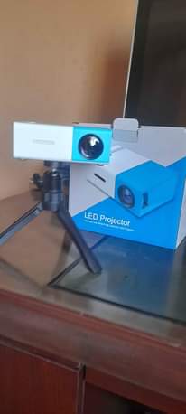 A picture of Promo Mini projector with FREE tripod stand for perfect balance