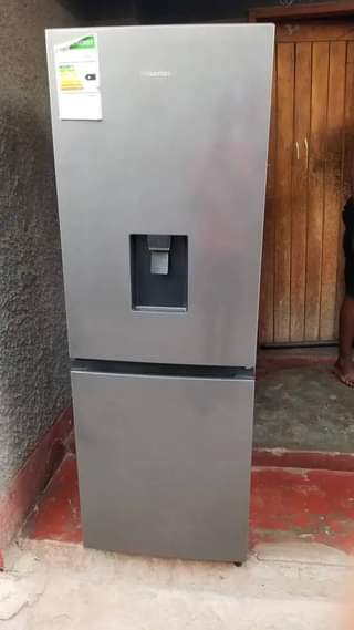 A picture of Hisense clean fridge with water dispenser at 600k urgent money