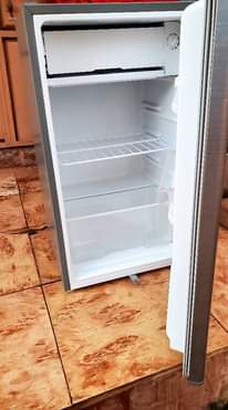 A picture of Hisense tv frameless 32 inches and changhong fridge 120 litres