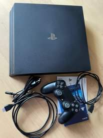 A picture of playstation 4 pro with 1 controller and free gta v