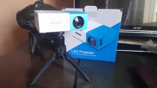 A picture of Mini projector with FREE tripod stand and anti light screen